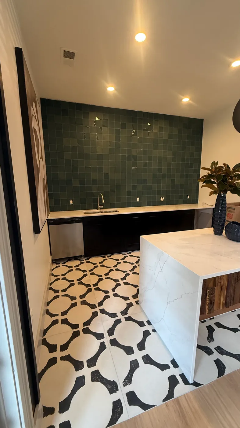 Black and white patterned floor tile with marble waterfall island in Chapel Hill clubhouse